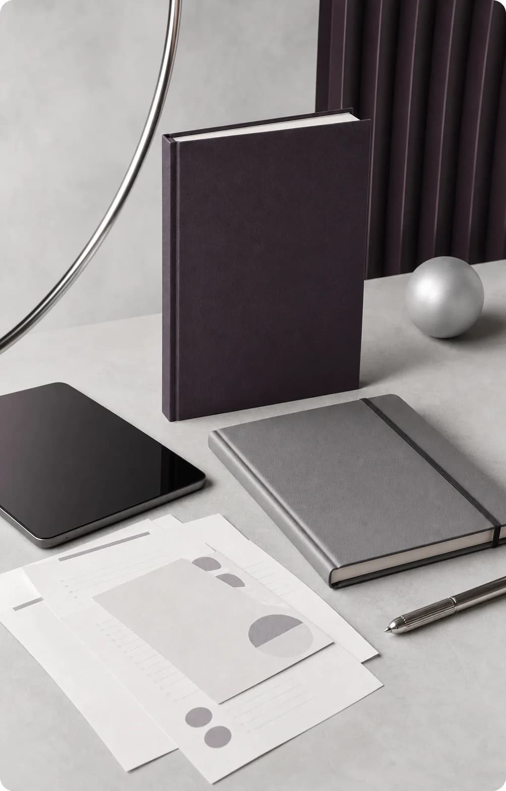 Books, a planner, a tablet, and worksheets in a studio arrangement